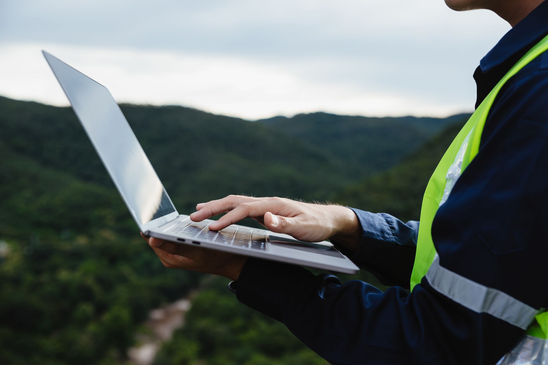 HSE manager on site with a laptop